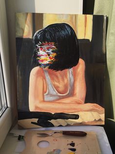 a painting of a woman's face is being worked on