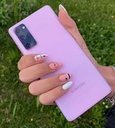 a woman's hand holding up a purple samsung phone case with hearts on it