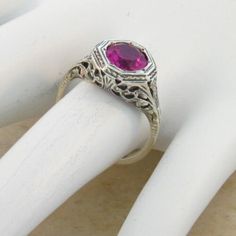 Vintage Estate 2.00 Carat Lab Created Ruby Solitaire Filigree Ring. Floral Designs. 925 Solid Sterling Silver. The Top Of The Ring Measures 3/8 Inches In Length. Set With One 6.5 mm High Quality Lab Created Ruby Stone. Stamped 925. Excellent Condition/Like New. Classic Ruby Birthstone Ring For Valentine's Day, Vintage Hallmarked White Gold Ruby Ring, Hallmarked Vintage White Gold Ruby Ring, Classic Silver Ruby Ring For Valentine's Day, Classic Round Ruby Ring For Valentine's Day, Classic Pink Ruby Ring For Anniversary, Classic Lab-created Ruby Jewelry For Wedding, Classic Pink Ruby Ring For Formal Occasions, Silver Ruby Wedding Jewelry