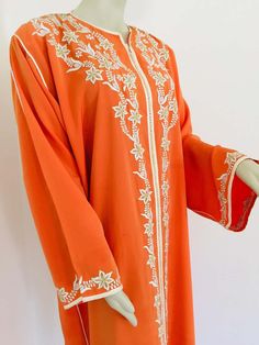 For Sale on 1stDibs - Elegant Moroccan caftan orange color embroidered with gold trim, circa 1970s. This long maxi dress kaftan trim is embroidered and embellished with pearls Orange Long Sleeve Dress For Eid, Elegant Orange Dress For Festivals, Orange Embroidered Floor-length Dress, Embroidered Orange Floor-length Dress, Elegant Long Orange Kaftan, Maxi Kaftan With Intricate Embroidery For Traditional Ceremonies, Maxi Length Embroidered Kaftan For Traditional Ceremonies, Traditional Orange Dress With Intricate Embroidery, Traditional Long Sleeve Orange Kaftan