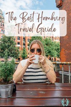 a woman sitting at a table holding a coffee cup with the words the best hamming travel guide