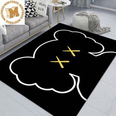 a black rug with white clouds and crosses on the floor in front of a couch