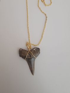 Hand picked Prehistoric Mako Shark Tooth made onto an 18 inch Gold plated necklace! Tooth size is 1 3/4 inches long! Perfect condition!! Est. Age 16 million years old Gold Arrowhead Necklace As A Gift, Gold Arrowhead Necklace Gift, Gold Arrowhead Necklace For Gift, Nickel-free Arrowhead Necklace Gift, Nickel-free Arrowhead Necklace For Gift, Nickel Free Arrowhead Necklace For Gift, Mako Shark, Shark Tooth Necklace, Tooth Necklace