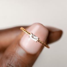 This baguette ring features a twisted gold band and a baguette cut gemstone at its center.  The center gemstone measures 5mm x 2.5mm.  Made with cubic zirconia.  Size: 5, 6, 7, 8, 9 Wedding Rings For Petite Hands, Promise Ring Gold Simple, Small Baguette Ring, Promise Rings Danty, Gold Ring Gemstone, Dainty Aquamarine Ring, Good Promise Ring, Simple Gold Promise Rings, Promise Rings For Her Simple