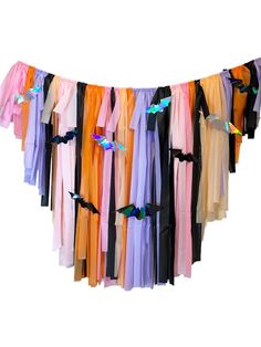 an assortment of colorful scarves hanging from a line on a clothes line with clips