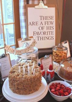 a table topped with lots of food and desserts next to a sign that says these are a few of his favorite things