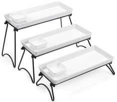 three white trays sitting on top of each other with black metal legs and feet