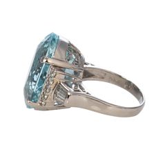 From our estate and antique collection, this vintage ring features an oval aquamarine center prong set in a platinum mounting with side round and baguette diamond accents. Aquamarine Total Weight: 17.99 ct Diamond Total Weight: 0.65 ct Ring Size: 6 This is a special piece of jewelry from our estate collection. We hope you will enjoy the character and imperfections that are associated with a vintage item. Diamond Platinum Ring, Platinum Diamond Rings, Platinum Ring, Baguette Diamond, Vintage Ring, Antique Collection, Prong Setting, Vintage Rings, Aquamarine