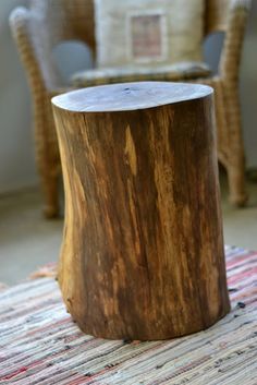 a wooden stump sitting on top of a rug