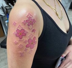 a woman with pink flowers on her arm