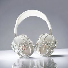 a pair of headphones sitting on top of a white table next to each other