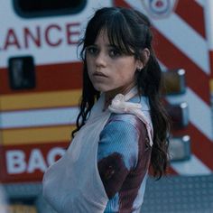 a woman standing in front of an ambulance