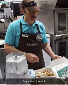 a man wearing an apron and blindfold is making food