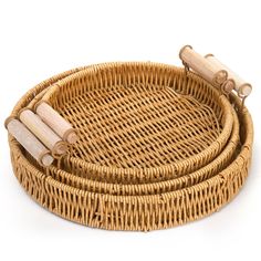 a wicker basket with bamboo handles is shown on a white background and has three wooden rods attached to it