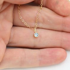 Very classy, simple, and dainty. This handcrafted gold pendant has a natural Blue Topaz stone and comes on your choice of a 16 or an 18 inch gold chain with the artist's tag attached to the clasp. It can also be paired with other pendants! Mix and match to create your own personalized necklace or mother necklace! Gold is 14ky. Stone measures 3mm in diameter. Birthstone for December. All Laine Benthall jewelry comes with a lifetime warranty. This pendant can also be purchased without the chain, j Blue Topaz Round Pendant Necklace Gift, Gift Blue Topaz Round Pendant Necklace, Gold Necklace With Blue Topaz Birthstone, Minimalist Gold Jewelry With Blue Topaz, Minimalist Blue Topaz Birthstone Jewelry, Delicate Blue Topaz Birthstone Jewelry, Minimalist Everyday Blue Topaz Jewelry, Fine Jewelry Blue Topaz Birthstone Necklace For Gifts, Yellow Gold Necklace With Blue Topaz Birthstone