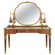 an antique vanity with mirror and candles on it