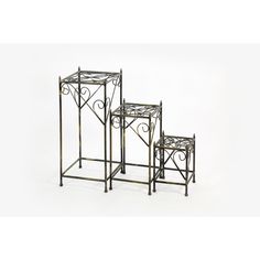 two metal plant stands sitting next to each other