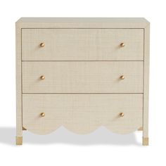 a white dresser with two drawers and gold knobs on the bottom, against a white background