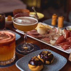 a table topped with plates of food and drinks