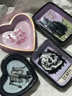 three heart shaped trays with different designs on them