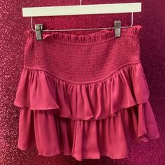 Hot Pink Flowy Ruffled Mini Skirt For Brunch, Trendy Ruffled Skirt For Day Out, Chic Tiered Pleated Bottoms, Chic Pleated Tiered Bottoms, Chic Ruffled Mini Skirt For Date Night, Spring Tiered Skirt For Date Night, Chic Pink Tiered Bottoms, Chic Tiered Mini Skirt With Elastic Waistband, Chic Ruffled Mini Skirt For Brunch