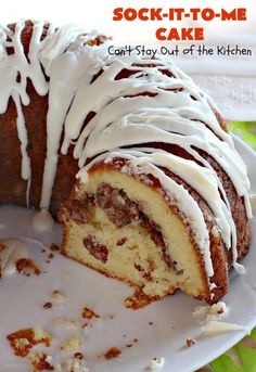 a white plate topped with a bundt cake covered in icing and sliced into slices