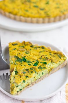 a slice of quiche on a plate with a fork