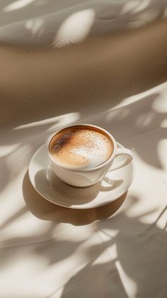 a cappuccino sitting on top of a white saucer