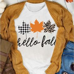 a white shirt with the words hello fall printed on it and an orange maple leaf