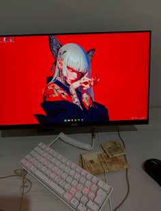 a desktop computer with a red background and anime character on the screen, sitting next to a keyboard