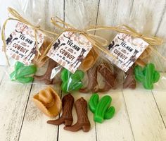 three bags filled with chocolate covered candies sitting on top of a wooden table