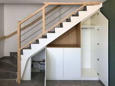 the stairs are built into the wall under the bannister and cupboards below