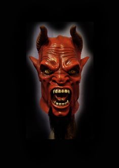 a red demon mask with horns on it's head