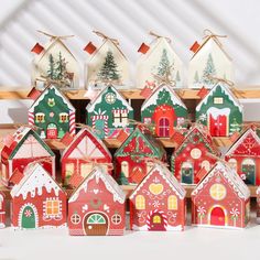 a group of christmas houses sitting on top of a shelf