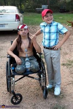 two people standing next to each other in front of a horse and carriage on dirt ground