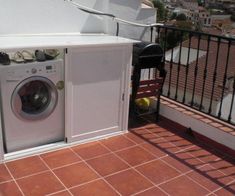 a washer and dryer sitting on top of a balcony