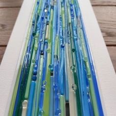 several blue, green and white toothbrushes lined up