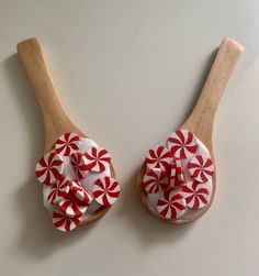 two wooden spoons with red and white fabric on them