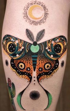 a woman's leg with an artistic tattoo design on it and a butterfly in the middle