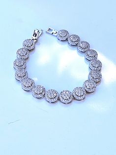 "Hello, welcome to Ken's Closet Today we have a beautiful CZ Diamond Bracelet. This is very sparkly. This bracelet is in a silver setting. Diamonds are AAA Certified and sparkle beautifully. We offer this style in 2 different sizes. - 6\" - 7\"" Elegant Iced Out Round Bracelets, Elegant Iced Out Bracelets, Iced Out Elegant Bracelets, White Gold Cubic Zirconia Charm Bracelet, Silver Cubic Zirconia Diamond Bracelet Iced Out, Dazzling Silver Bracelets With Sparkling Stones, Silver Cubic Zirconia Iced Out Tennis Bracelet, Silver Bracelets With Sparkling Stones, Silver Chain Bracelet With Diamond Accents