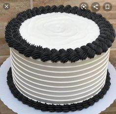 a white and black cake on top of a table