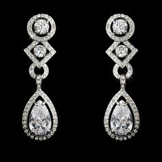 CZ Bridal and Formal EarringsAdd a glamorous touch to your wedding day or special occasion with these sparkling cz earrings. These beautiful cubic zirconia bridal earrings will add lots of sparkle to your bridal look. Available in both pierced and clip on styles, these earrings will be perfect for your special day.Color: Silver plated setting/clear stones.Size: 1.75" long and .5" wide.Style: 3824.Please allow 1 week for delivery.Shipping Policy.Return Policy Cubic Zirconia Bridal Earrings, Wedding Earrings Chandelier, Formal Earrings, Bridal Earrings Chandelier, Simple Silver Jewelry, Dazzling Earrings, Clear Earrings, Bridal Fashion Jewelry, Cubic Zirconia Earrings