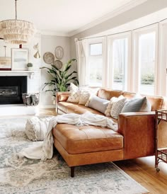 a living room filled with furniture and a fire place in the middle of the room