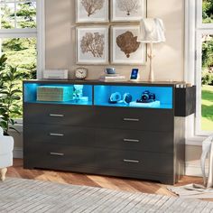 a modern dresser with blue lights on the top and bottom drawers in front of it