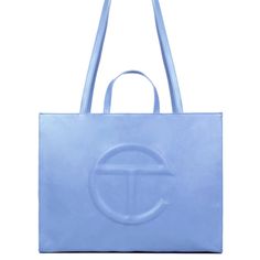 The Iconic Unisex Shopping Bag Is An Everyday Bag For Everyone. Featuring A Double Strap (Handles And Cross-Body Straps), Embossed Logo, A Main Compartment With Magnetic Snap Closure, Internal Laptop-Sized Compartment With Zipper Closure In Back And Additional Internal Pocket In Front. Made From Faux Leather And Twill Lining. Bag Is Packaged In A 100% Cotton Drawstring Bag With Screen-Printed Logo. Large Fits A Long Weekend And Is The Ultimate Carry-On. (Height 14 1/4", Width 19 1/4", Depth 8 Blue Double Handle Shoulder Bag With Logo, Blue Shoulder Bag With Logo And Double Handles, Luxury Blue Shoulder Bag With Logo, Blue Top Handle Shoulder Bag With Logo, Blue Top Handle Bag With Logo, Everyday Blue Bags With Logo, Designer Blue Shoulder Bag With Logo, Elegant Blue Bag With Logo, Elegant Blue Bags With Logo