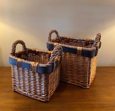 two wicker baskets sitting on top of a wooden table