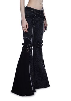 These pants have a stretchy twill construction with a printed filigree design, raw edge detailing, a raw hem and waistband, flare legs, a dual belt design on the legs with buckle closures, grommet detailing, front and back pockets, an adjustable crisscross waist belt closure, and a front button and zipper closure. Black Flare Pants With Belt Loops, Gothic Black Flare Bottoms, Fitted Punk Bottoms With Belt, Gothic Stretch Cotton Bottoms, Gothic Black Bottoms With Belt, Gothic Cotton Pants With Belt Loops, Edgy Black Flare Pants, Fitted Cotton Bottoms With Belt Detail, Gothic Black Wide Leg Pants