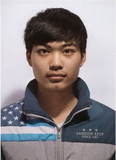 a young man with an american flag on his jacket