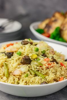 a bowl filled with rice and vegetables on top of a table