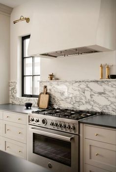 a stove top oven sitting inside of a kitchen